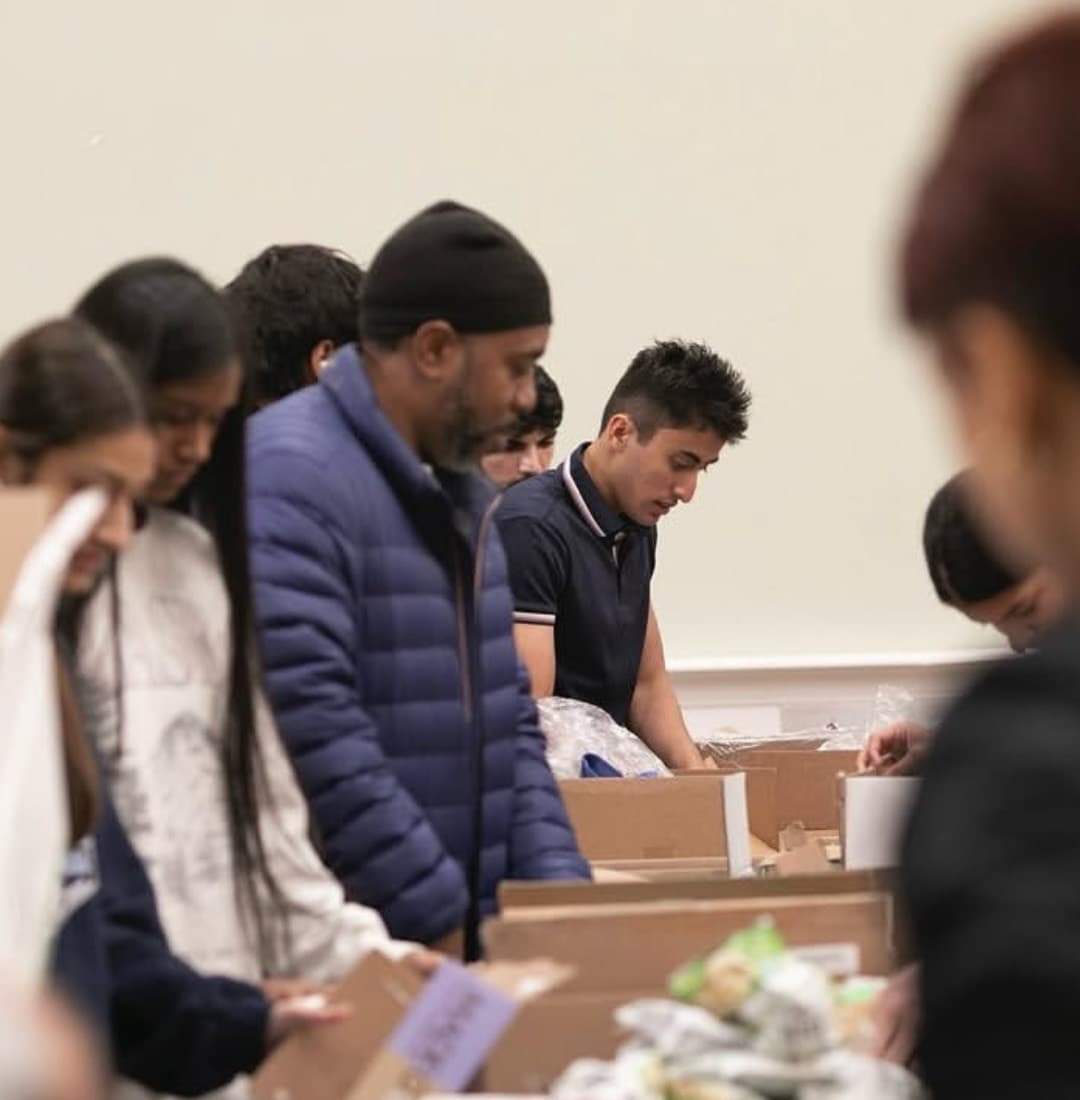 Medwell volunteers packing food boxes at a community drive